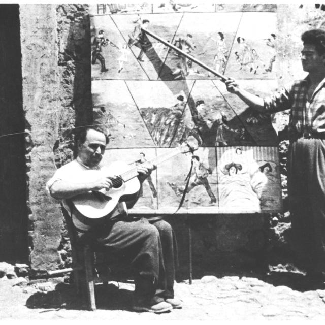 Orazio Strano (with guitar) and unidentified man in front of tableau